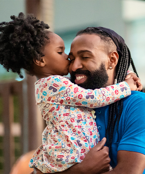 Father holding daughter